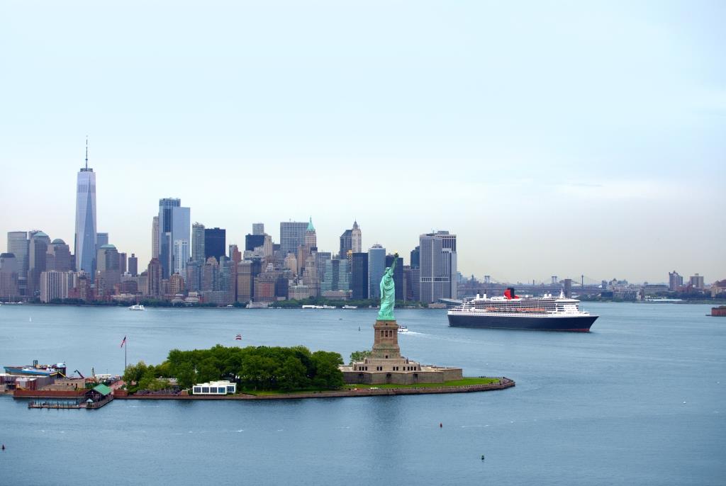 Die Queen Mary 2 fährt in New York an der Freiheitsstatue vorbei